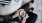 business woman sits next to a marble table with books and holds a saucer with a cup of espresso