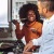 a man and a woman cooking on a gas stove top